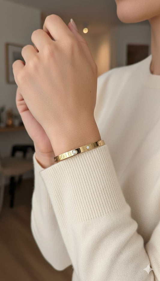 Elegant Screw Motif Gold-Finish Oval shaped Bangle with Stone Detailing